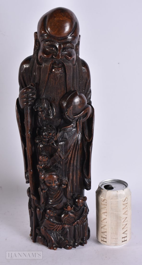 A LARGE 18TH CENTURY CHINESE CARVED BAMBOO FIGURE OF SAGE modelled holding a peach. 42.5 cm high. (1 of 8)