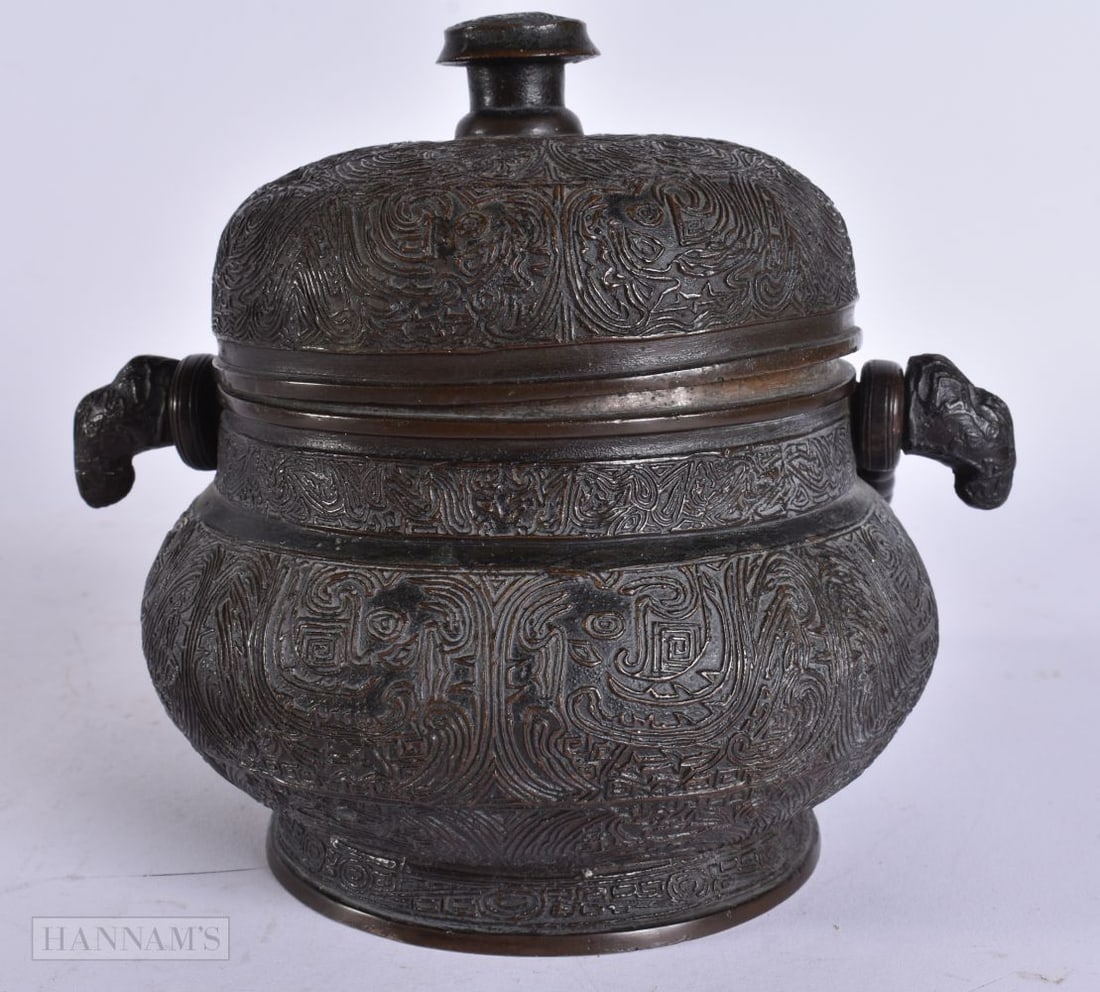 A FINE 18TH CENTURY CHINESE BRONZE SWING HANDLED CENSER AND COVER decorated all over with motifs and (1 of 8)