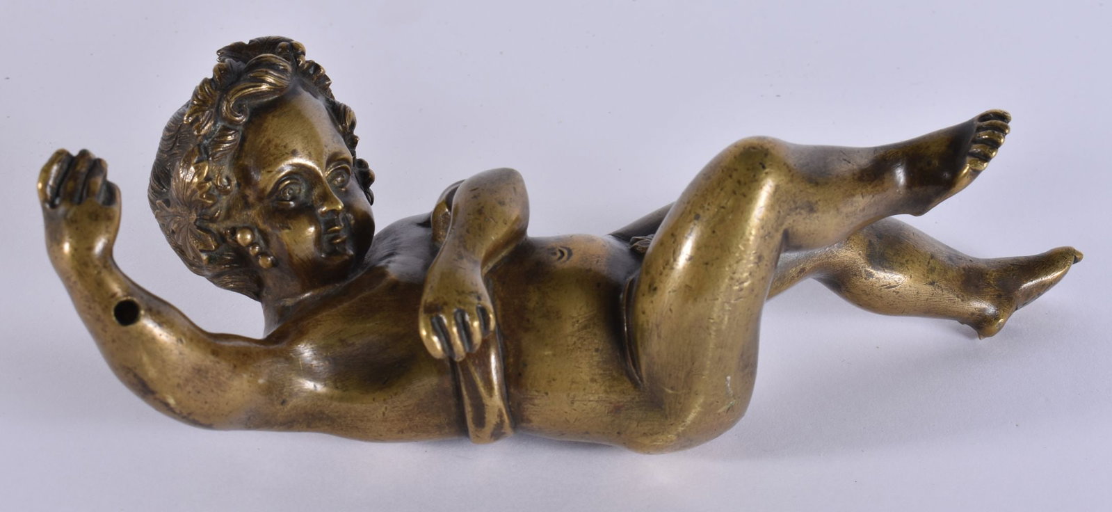 AN 18TH/19TH CENTURY GRAND TOUR BRONZE FIGURE OF A PUTTI modelled with one arm raised. 19 cm high.: AN 18TH/19TH CENTURY GRAND TOUR BRONZE FIGURE OF A PUTTI modelled with one arm raised. 19 cm high.