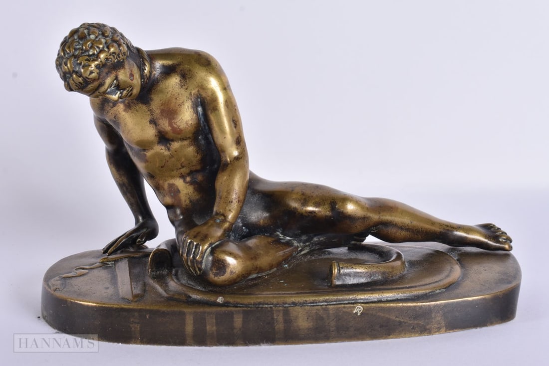 A 19TH CENTURY GRAND TOUR BRONZE FIGURE OF THE DYING GAUL modelled upon an oval base. 24.5 cm wide.: A 19TH CENTURY GRAND TOUR BRONZE FIGURE OF THE DYING GAUL modelled upon an oval base. 24.5 cm wide.