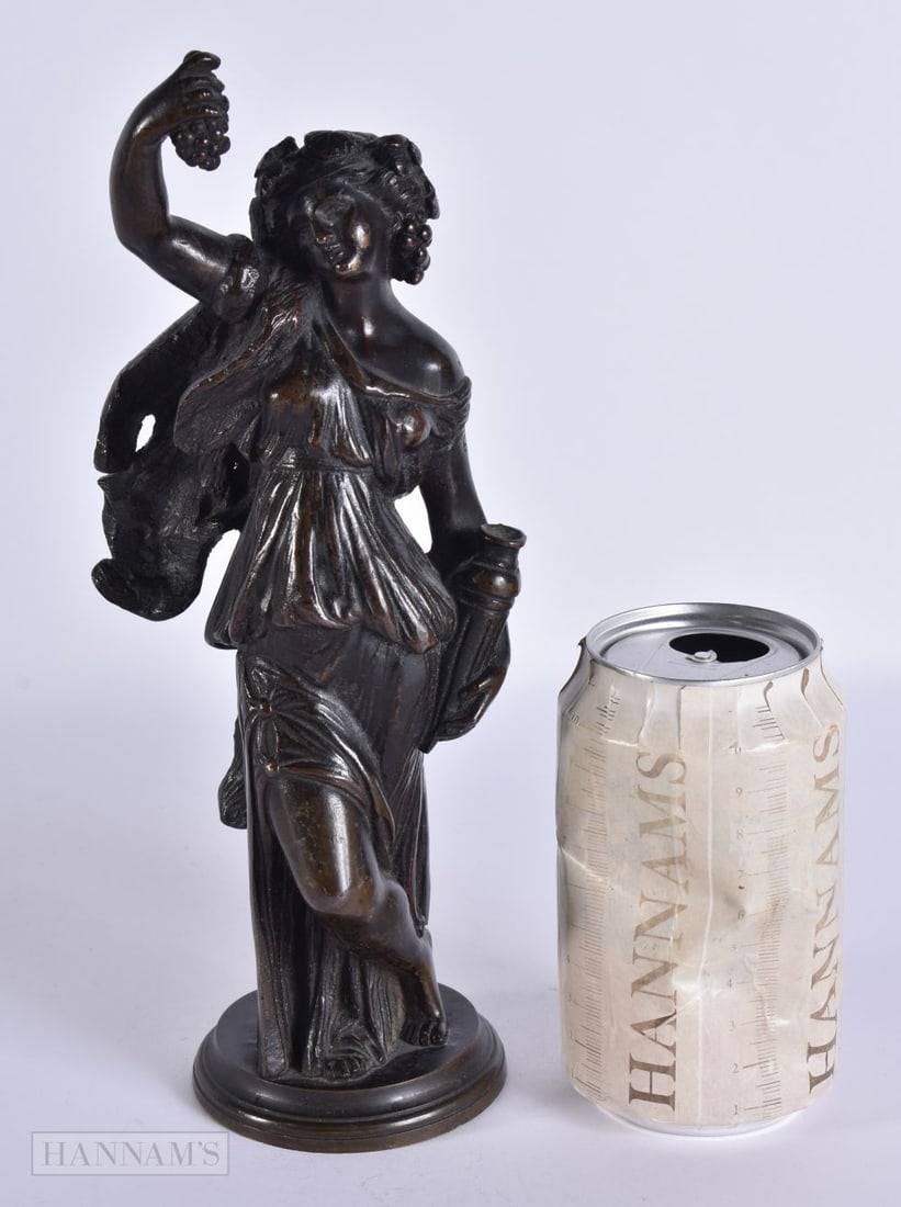AN 18TH/19TH CENTURY GRAND TOUR BRONZE FIGURE OF A CLASSICAL FEMALE modelled holding berries. 26cm h: AN 18TH/19TH CENTURY GRAND TOUR BRONZE FIGURE OF A CLASSICAL FEMALE modelled holding berries. 26cm high.