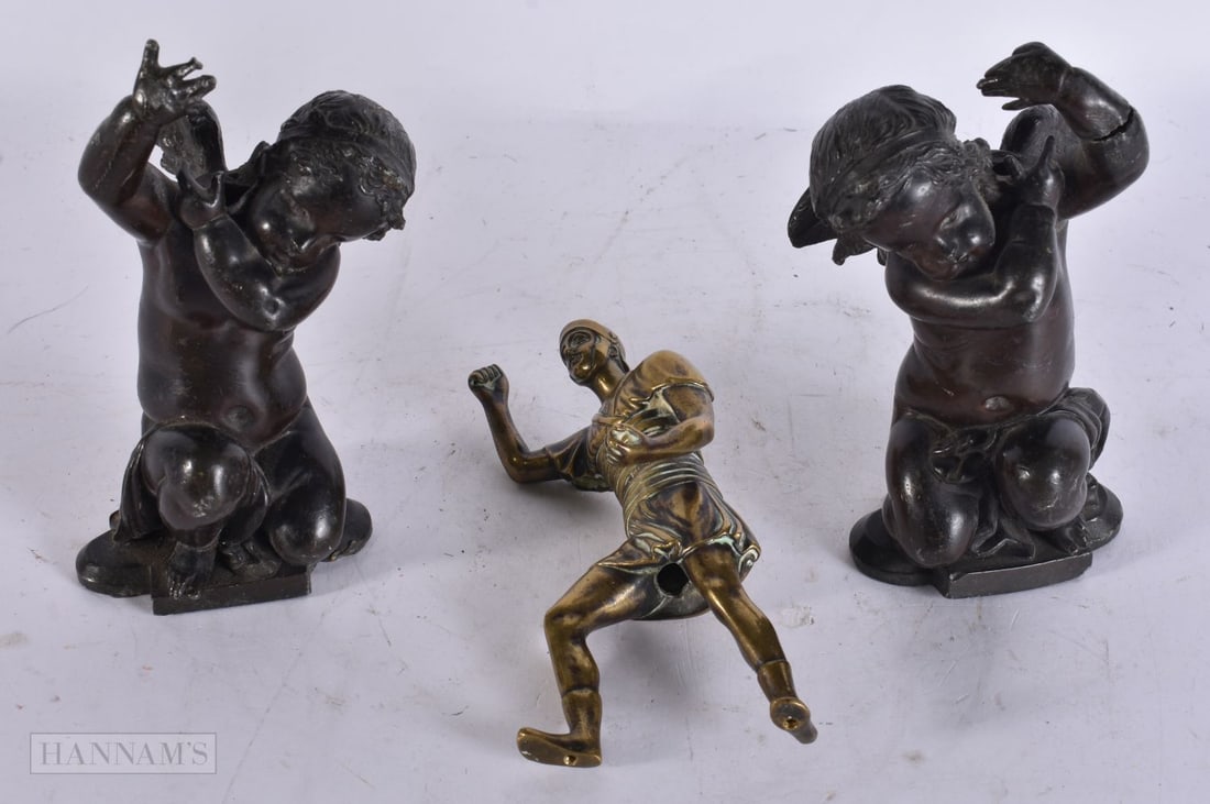 A 19TH CENTURY GRAND TOUR BRONZE FIGURE OF A ROMAN SOLDIER together with a pair of putti. 14.5 cm hi (1 of 3)
