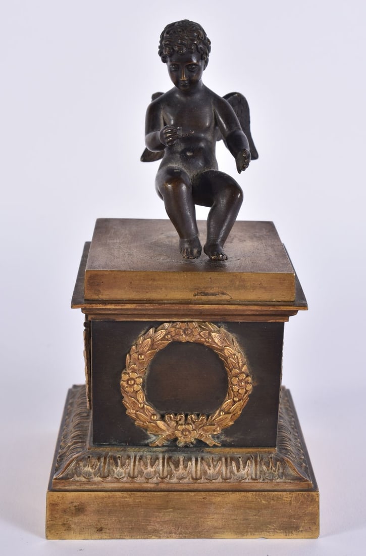A MID 19TH CENTURY FRENCH BRONZE INKWELL AND COVER formed with a seated putti upon a classical base. (1 of 7)