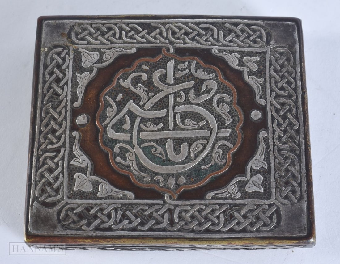 A 19TH CENTURY ISLAMIC SILVER INLAID MIDDLE EASTERN BOX decorated with scripture and entwined motifs (1 of 4)