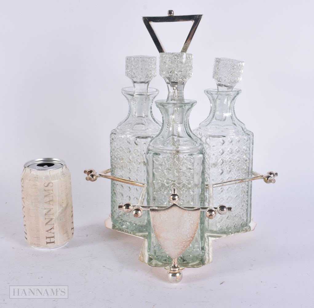 A SILVER PLATED GLASS TANTALUS. 32 cm high.: A SILVER PLATED GLASS TANTALUS. 32 cm high.