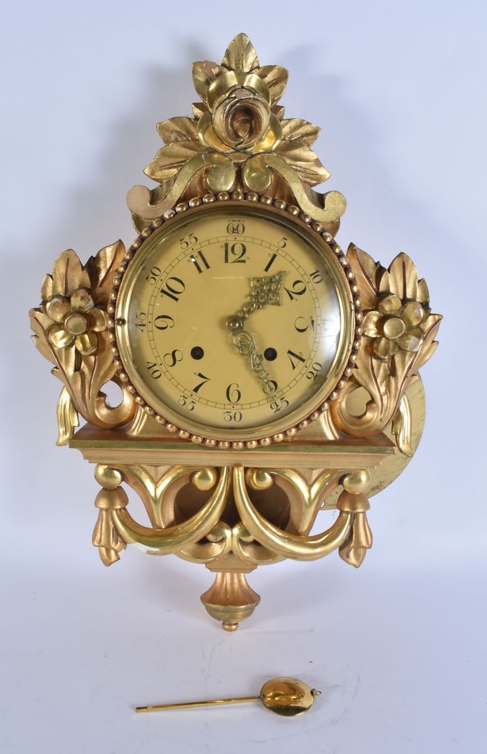 A GILT WOOD CARTEL CLOCK. 48 cm x 28cm. (1 of 4)