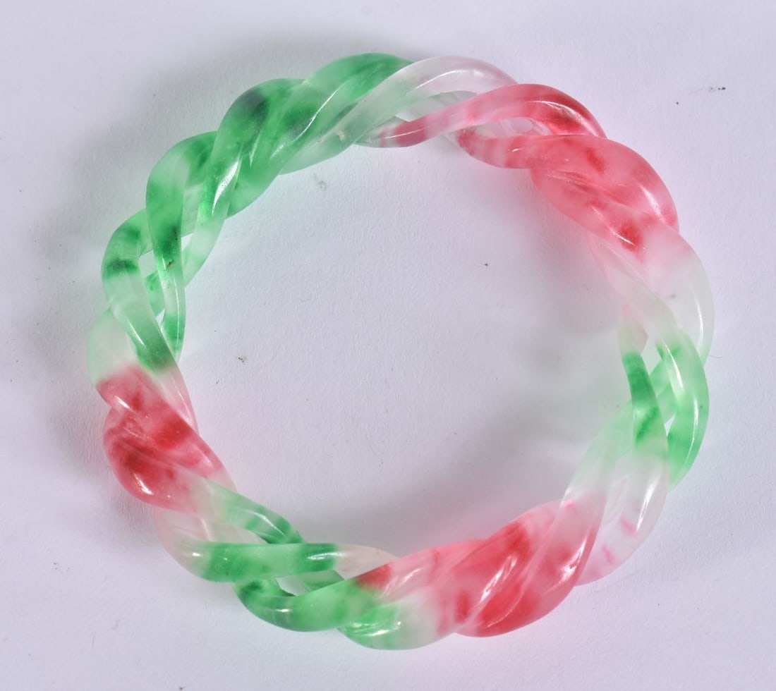 A CHINESE MULTI TONE JADE TWIST BANGLE. 6 cm internal diameter. (1 of 4)