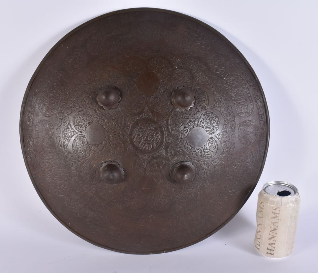 AN ANTIQUE MIDDLE EASTERN SHIELD decorated with foliage and scripture. 42 cm wide. (1 of 6)