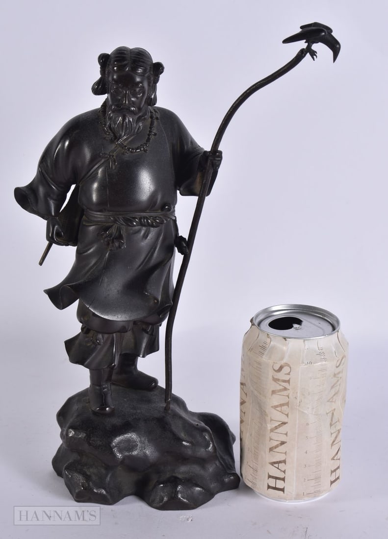 A 19TH CENTURY JAPANESE MEIJI PERIOD BRONZE OKIMONO modelled as a standing male holding a staff with (1 of 4)