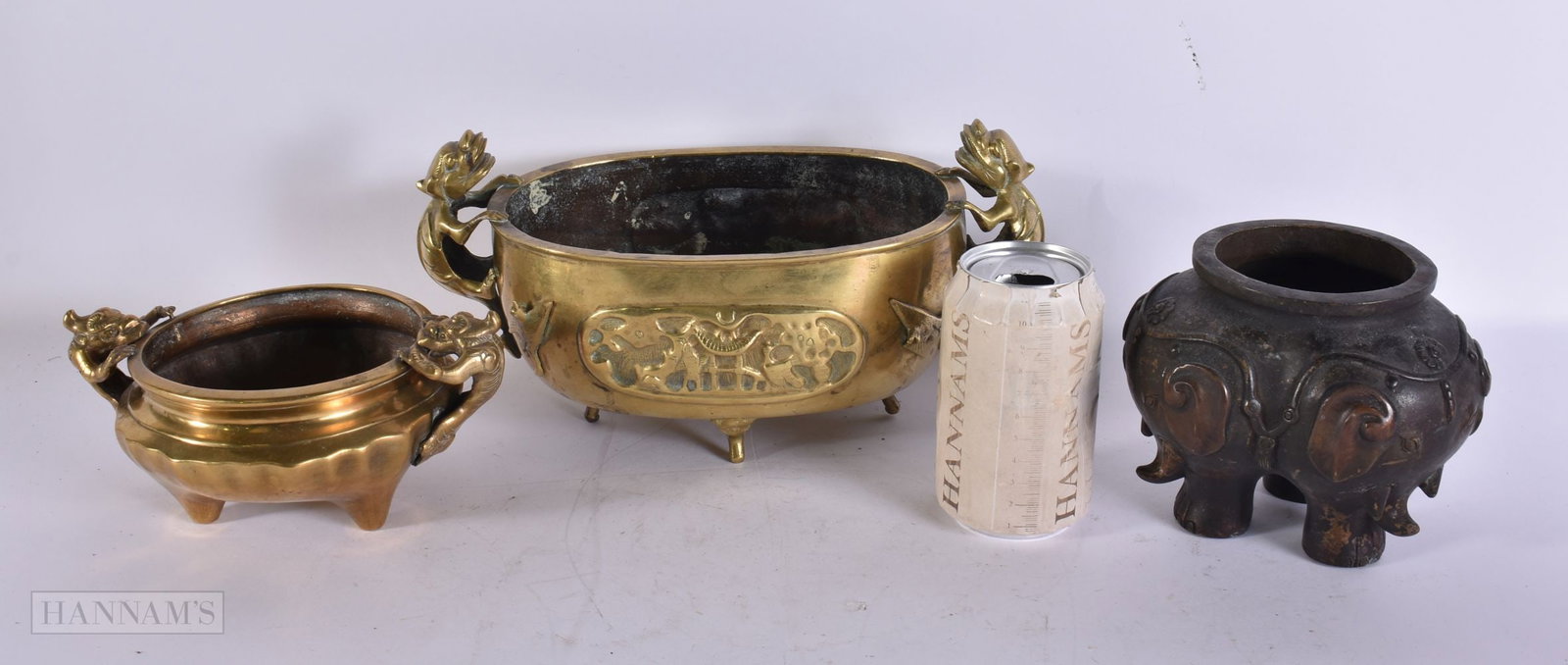 A 19TH CENTURY CHINESE TWIN HANDLED BRONZE CENSER Late Qing, together with two others. Largest 27cm (1 of 3)