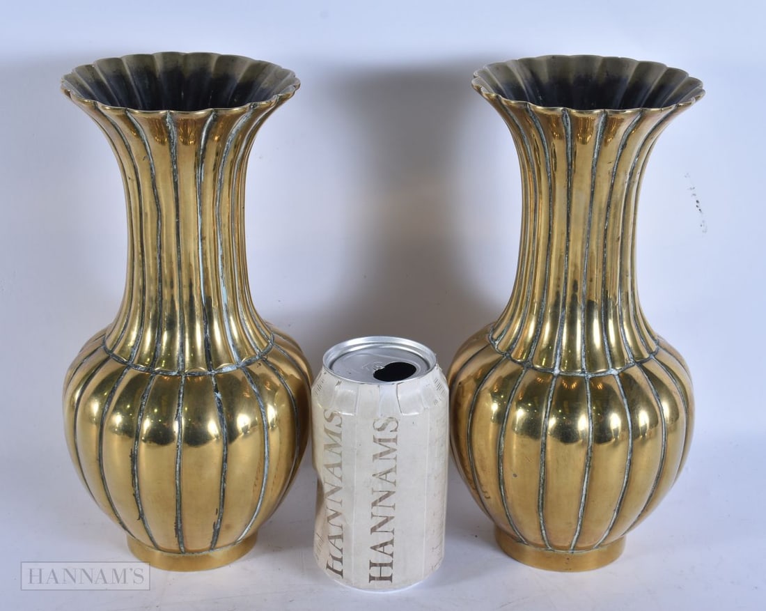A PAIR OF 19TH CENTURY CHINESE RIBBED BRONZE VASES bearing Xuande marks to base. 24 cm high.: A PAIR OF 19TH CENTURY CHINESE RIBBED BRONZE VASES bearing Xuande marks to base. 24 cm high.