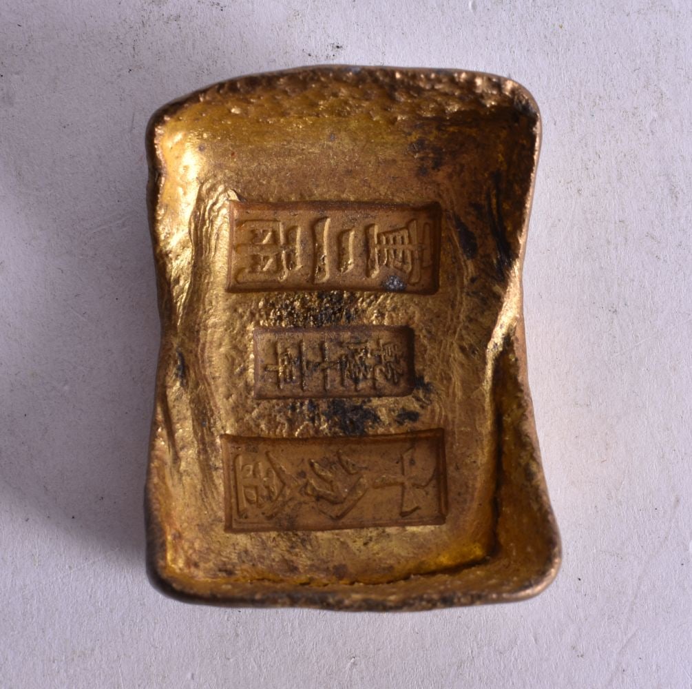 A CHINESE YELLOW METAL INGOT. 197 grams. 6 cm x 4 cm.: A CHINESE YELLOW METAL INGOT. 197 grams. 6 cm x 4 cm.