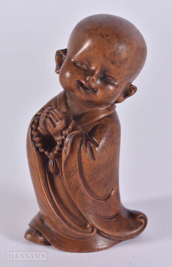 A CARVED WOOD FIGURE OF A BOY. 8.2 x 4.6 x 3.6 cm. (1 of 3)