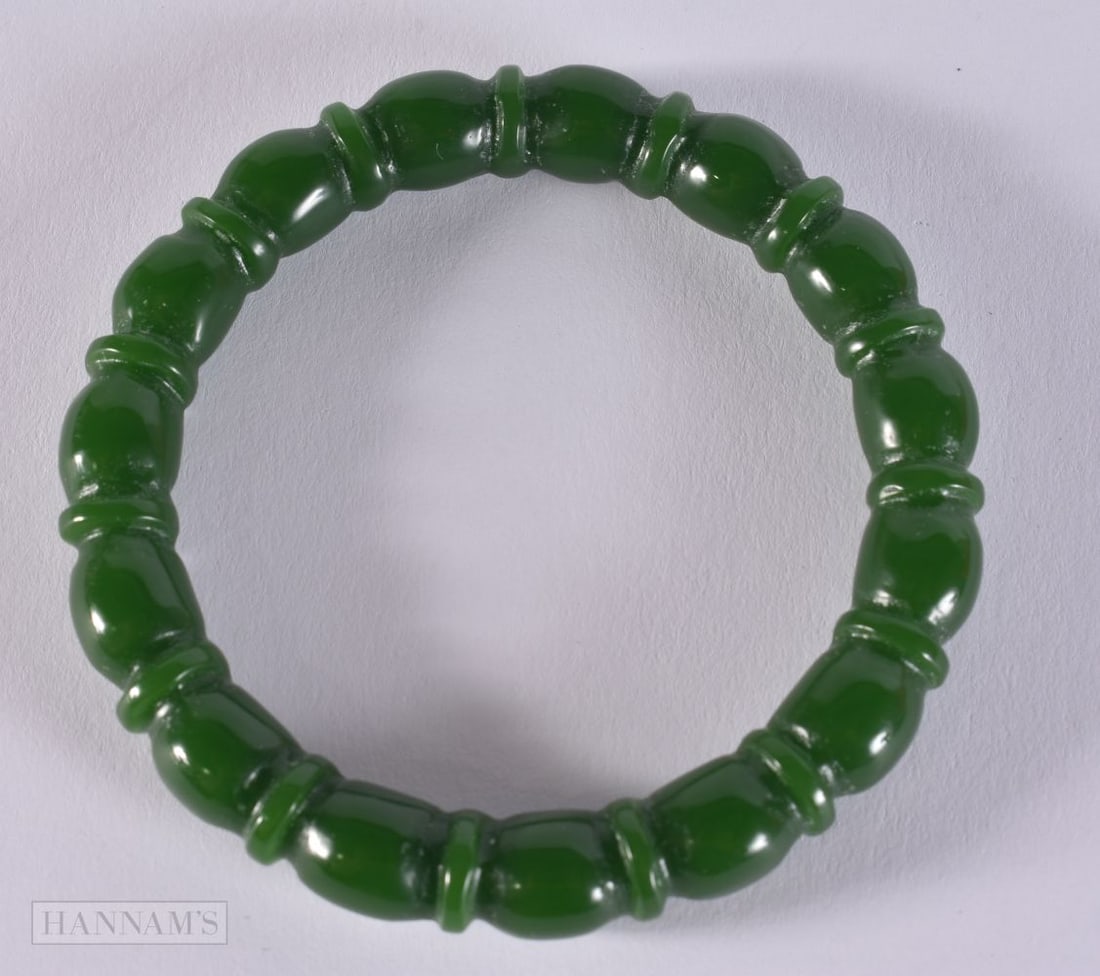 A RIBBED JADE BANGLE. 41.5 grams. 6 cm diameter. (1 of 3)