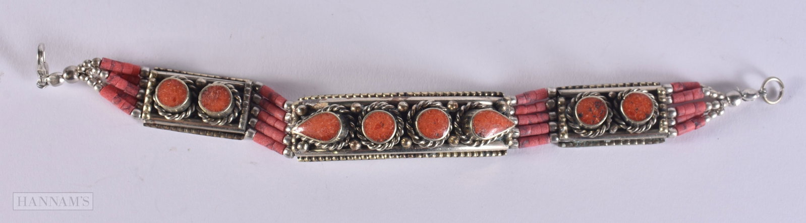 A TIBETAN WHITE METAL AND CORAL BANGLE. 19 x 1.5 cm.: A TIBETAN WHITE METAL AND CORAL BANGLE. 19 x 1.5 cm.
