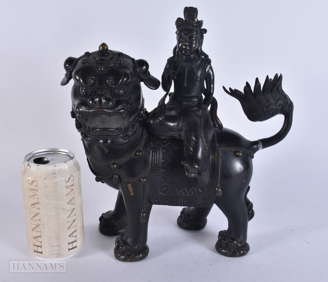 AN 18TH/19TH CENTURY CHINESE BRONZE CENSER AND COVER formed as a beast with seated immortal. 28cm x: AN 18TH/19TH CENTURY CHINESE BRONZE CENSER AND COVER formed as a beast with seated immortal. 28cm x 21 cm.
