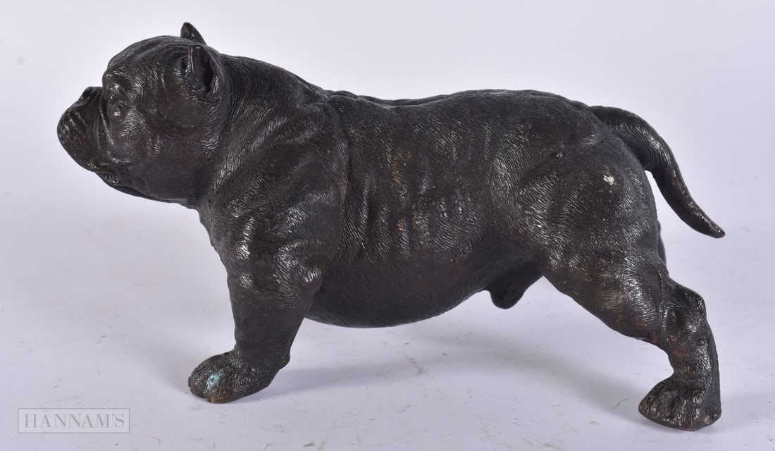 A CHINESE BRONZE DOG. 18 cm wide.: A CHINESE BRONZE DOG. 18 cm wide.