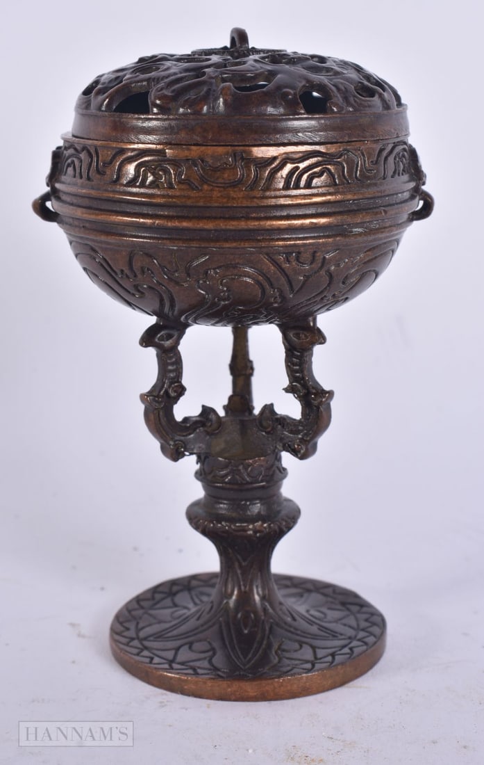 A CHINESE BRONZE CENSER AND COVER. 10 cm high.: A CHINESE BRONZE CENSER AND COVER. 10 cm high.