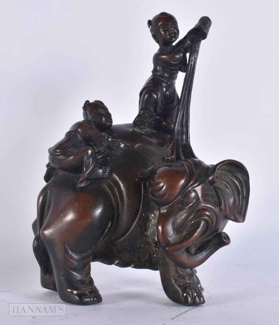 A CHINESE BRONZE ELEPHANT FIGURE. 22cm x 12 cm. (1 of 3)