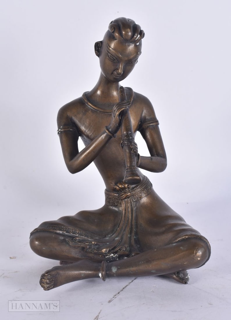AN EASTERN BRONZE MUSICIAN. 20cm high. (1 of 4)