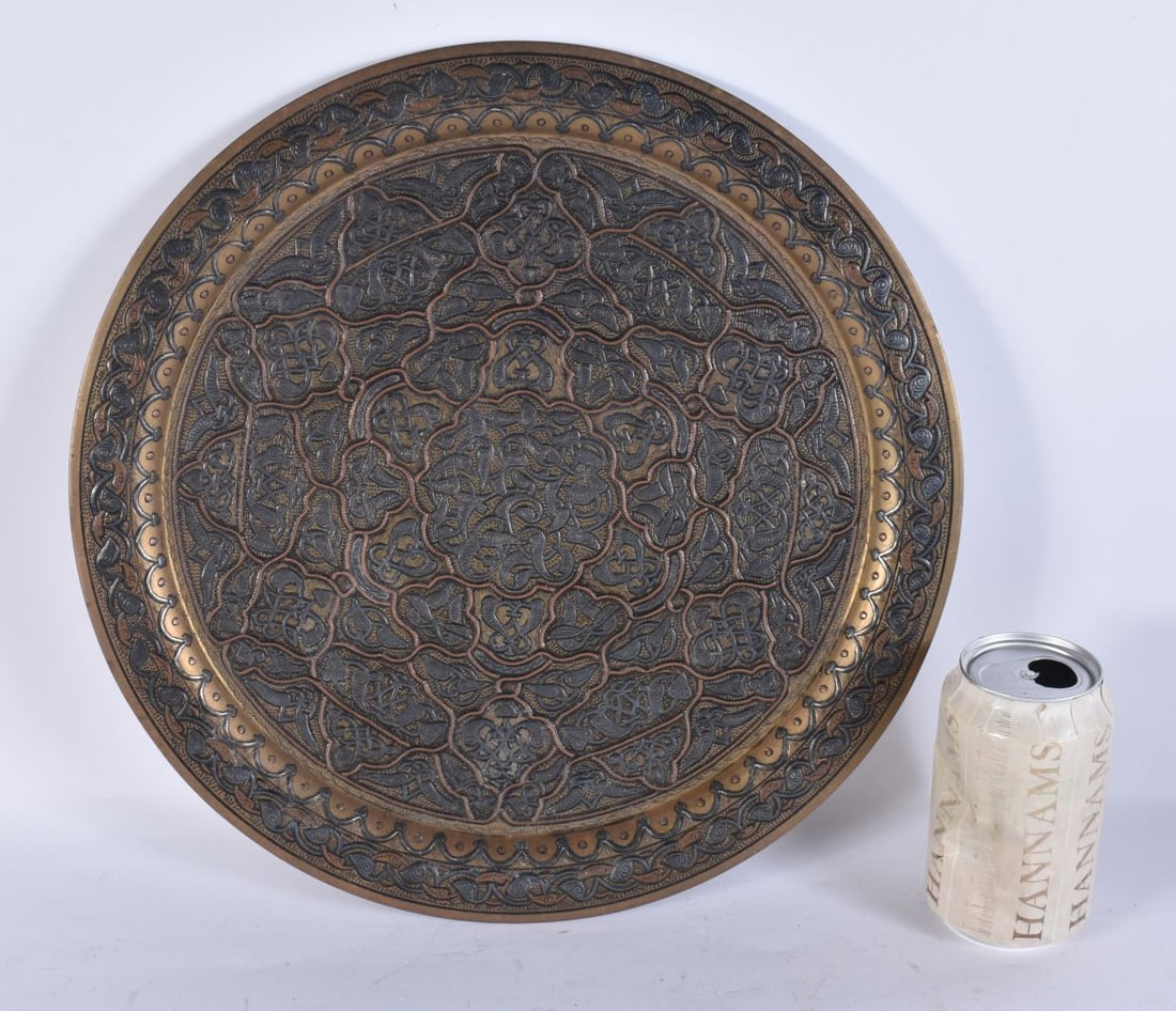 AN EARLY 20TH CENTURY MIDDLE EASTERN SILVER INLAID ISLAMIC DISH decorated with motifs and foliage. 3 (1 of 5)