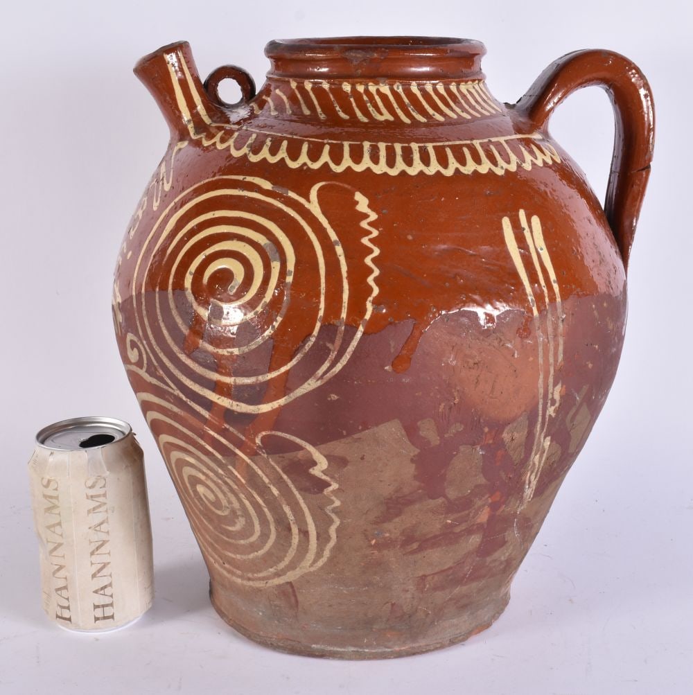 A 19TH CENTURY FRENCH POTTERY SLIP DECORATED OIL JUG. 34 cm x 22cm. (1 of 6)