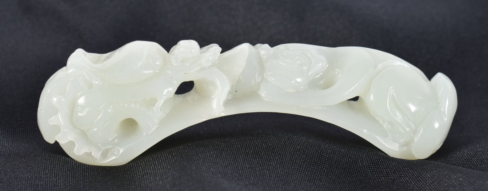 A CHINESE GREEN JADE BELT HOOK. 7.5 cm long. (1 of 6)