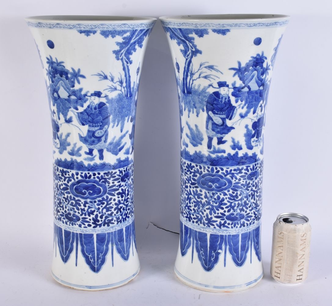 A FINE PAIR OF CHINESE QING DYNASTY BLUE AND WHITE PORCELAIN GU FORM VASES probably Kangxi, beautifu: A FINE PAIR OF CHINESE QING DYNASTY BLUE AND WHITE PORCELAIN GU FORM VASES probably Kangxi, beautifully painted with immortals within landscapes. 45cm x 20cm.