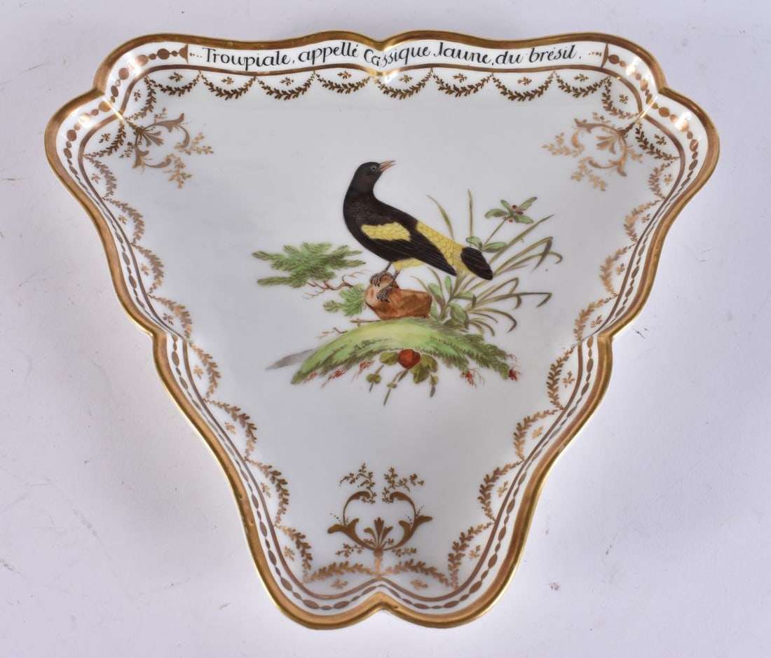 A FINE AND RARE EARLY 19TH CENTURY FRENCH PORCELAIN DISH painted with a bird within a gilded border. (1 of 6)
