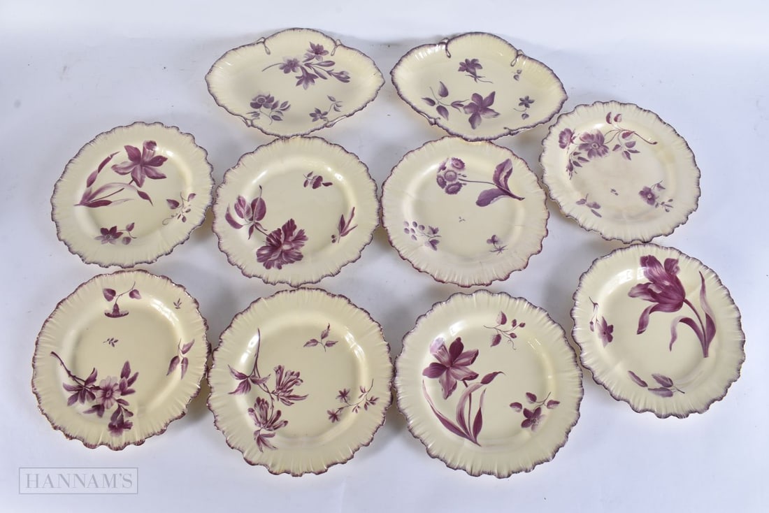 AN UNUSUAL SET OF EARLY 19TH CENTURY CREAMWARE BOTANICAL PLATES painted in puce with flowers. Larges: AN UNUSUAL SET OF EARLY 19TH CENTURY CREAMWARE BOTANICAL PLATES painted in puce with flowers. Largest 24.5 cm wide. (10)