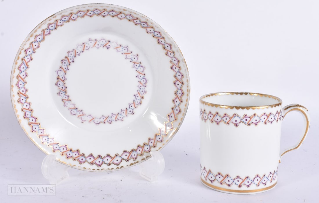 A 19TH CENTURY FRENCH SEVRES PORCELAIN CUP AND SAUCER painted with motifs. 11.5 cm wide. (2): A 19TH CENTURY FRENCH SEVRES PORCELAIN CUP AND SAUCER painted with motifs. 11.5 cm wide. (2)