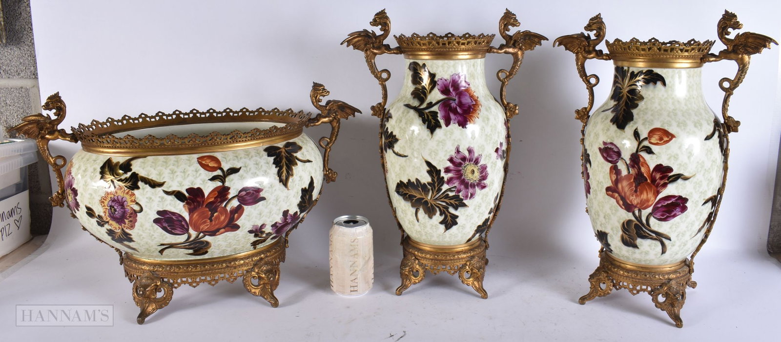 A LARGE 19TH CENTURY FRENCH BRONZE AND POTTERY GARNITURE painted with foliage, supported by griffins: A LARGE 19TH CENTURY FRENCH BRONZE AND POTTERY GARNITURE painted with foliage, supported by griffins and dragons. Bowl 42 cm x 30 cm, vase 42 cm x 16 cm. (3)