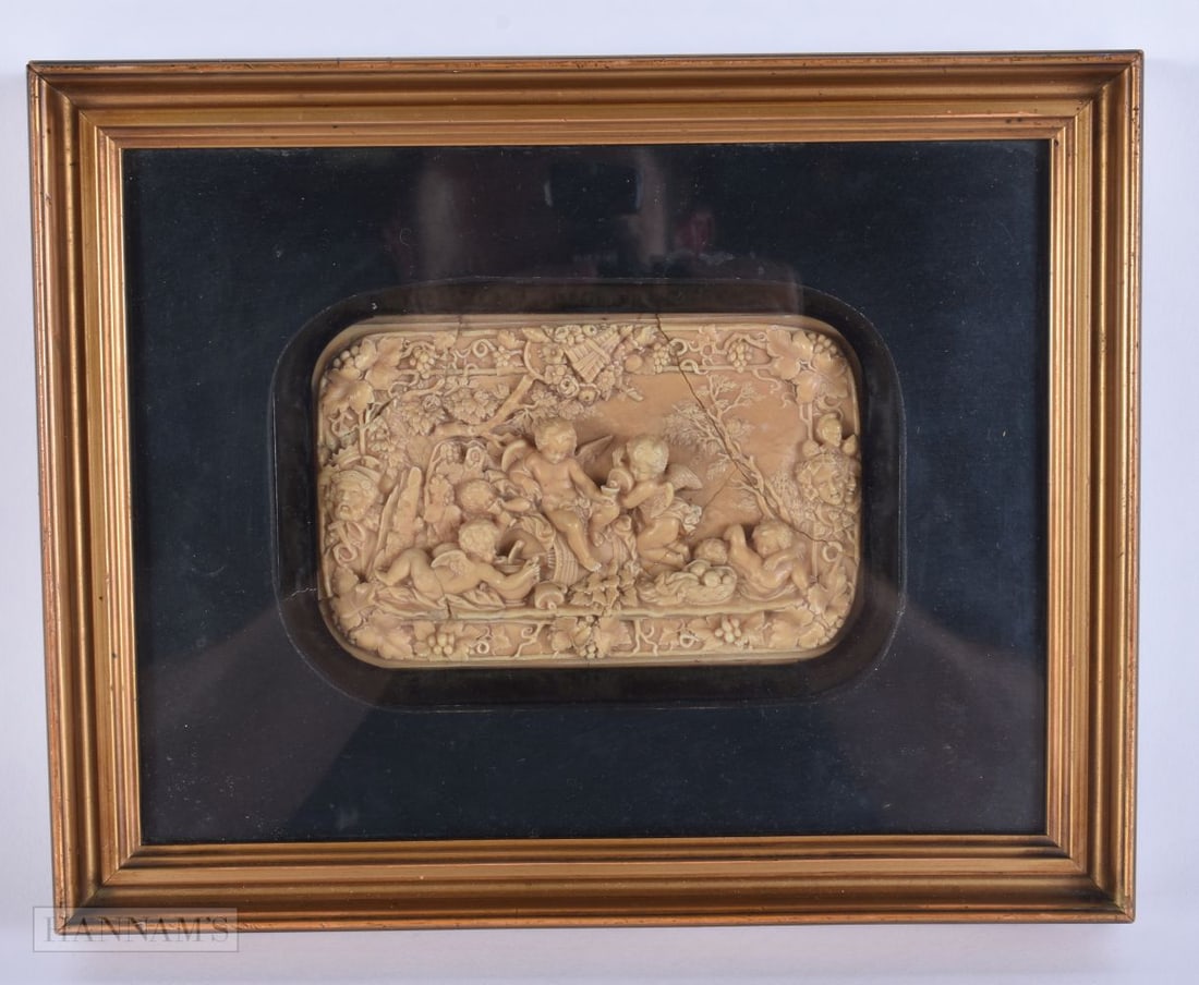 A FINE 18TH/19TH CENTURY ENGLISH WAX PLAQUE OF PUTTI modelled in various pursuits beside mask heads (1 of 10)