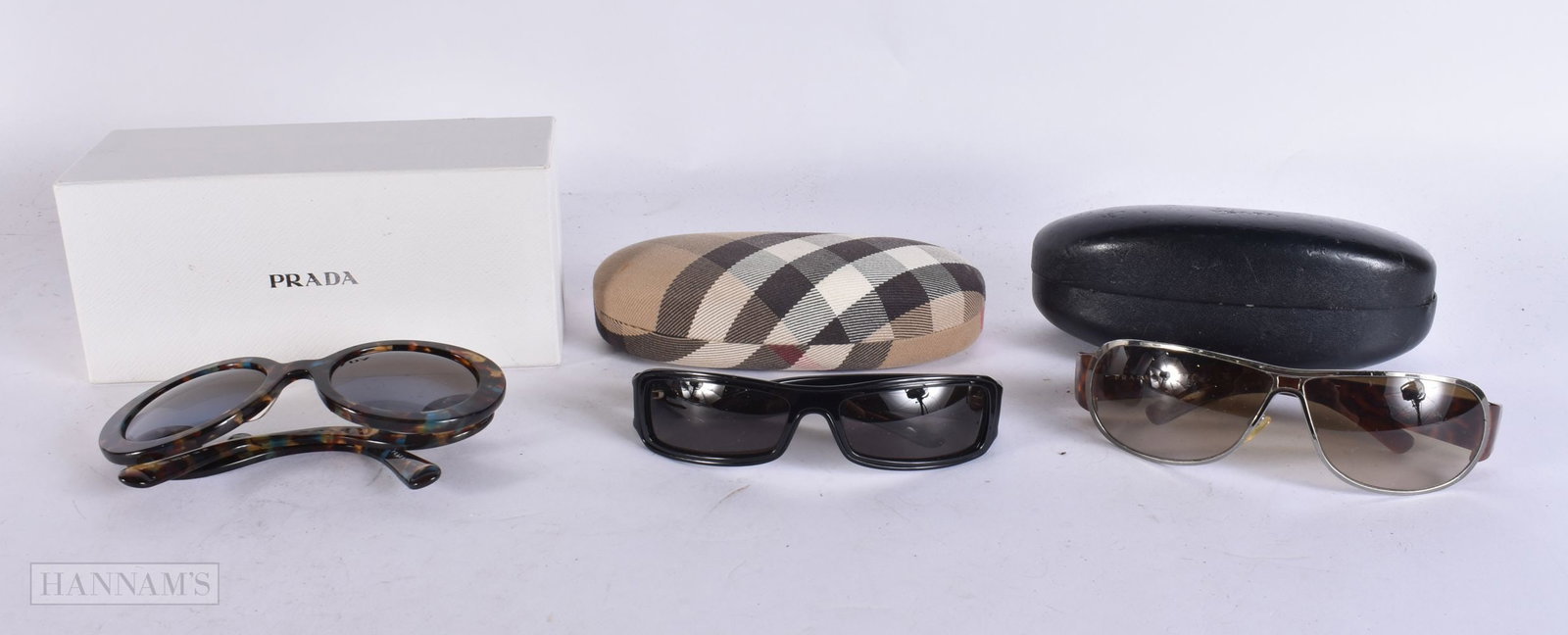 Designer Sunglasses Prada & Burberry Cased. (3) WE ARE UNABLE TO OFFER IN-HOUSE SHIPPING ON THIS LOT: Designer Sunglasses Prada & Burberry Cased. (3) WE ARE UNABLE TO OFFER IN-HOUSE SHIPPING ON THIS LOT TO USA AND CANADA