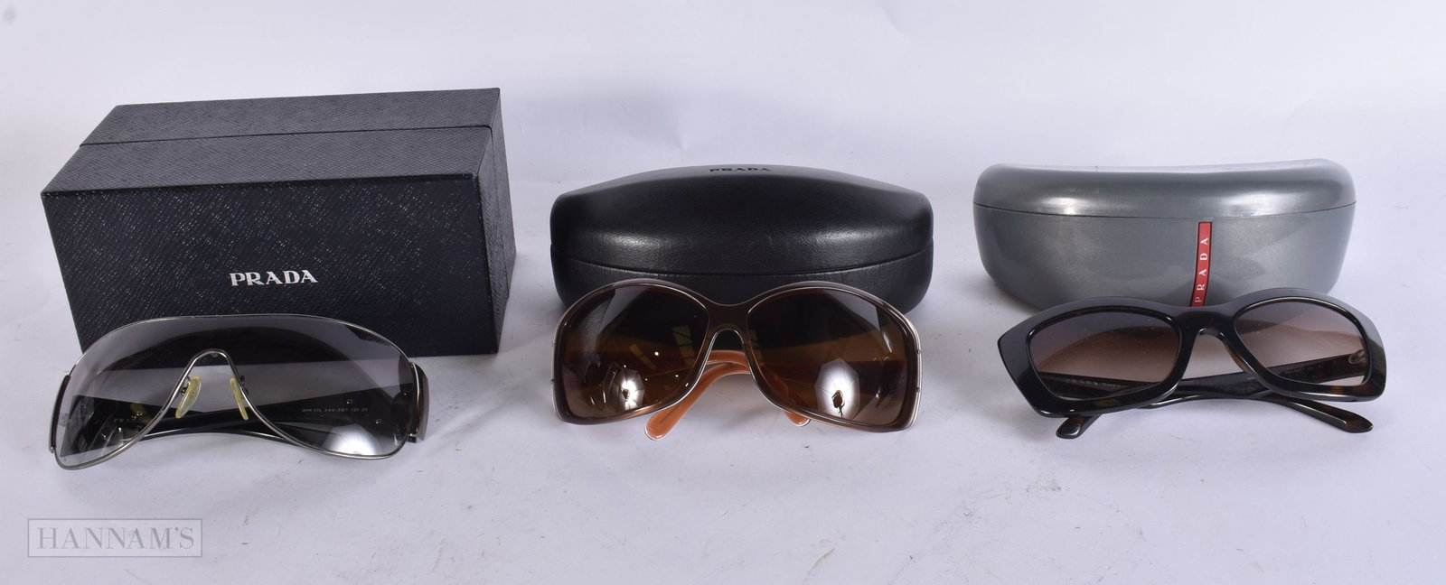 Prada Designer Sunglasses Cased Boxed. (3) WE ARE UNABLE TO OFFER IN-HOUSE SHIPPING ON THIS LOT TO: Prada Designer Sunglasses Cased Boxed. (3) WE ARE UNABLE TO OFFER IN-HOUSE SHIPPING ON THIS LOT TO USA AND CANADA