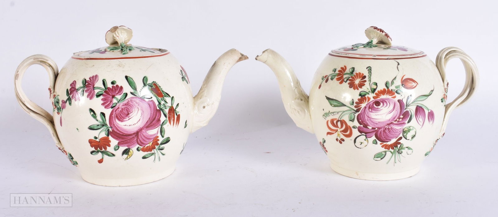 TWO 18TH CENTURY ENGLISH CREAMWARE TEAPOTS AND COVERS painted with flowers. 18 cm wide. (2) (1 of 6)