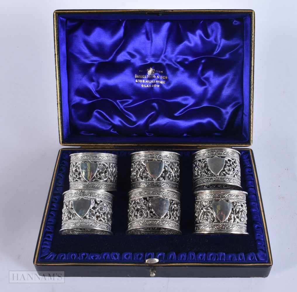 A CASED SET OF ANTIQUE SILVER NAPKIN RINGS. 210 grams. Box 20 cm wide. (1 of 5)
