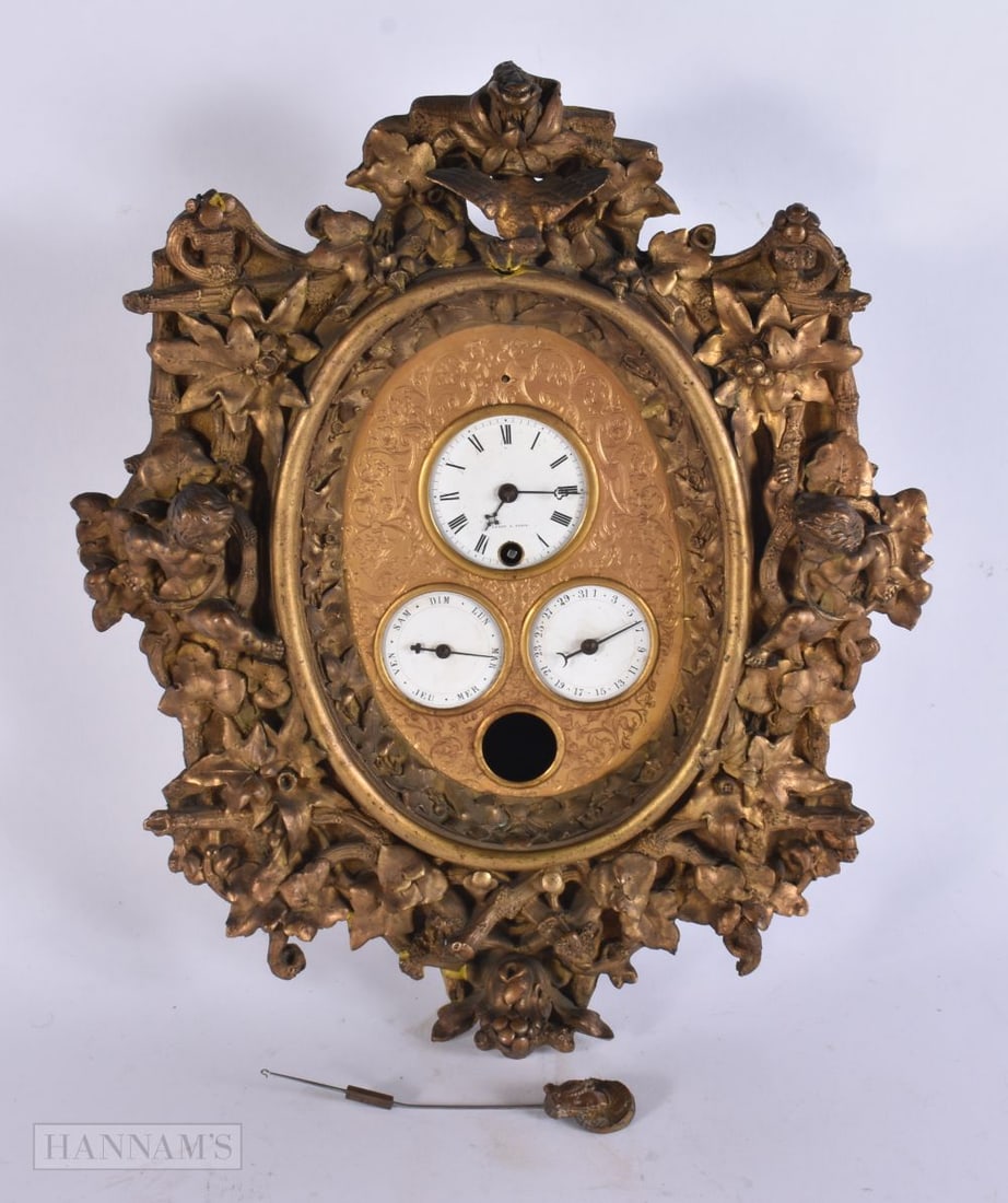 A 19TH CENTURY FRENCH GILT METAL REPOUSSE LEROY A PARIS CLOCK with central dial over two subsidiary: A 19TH CENTURY FRENCH GILT METAL REPOUSSE LEROY A PARIS CLOCK with central dial over two subsidiary dials, flanked by putti. 32 cm x 26 cm.
