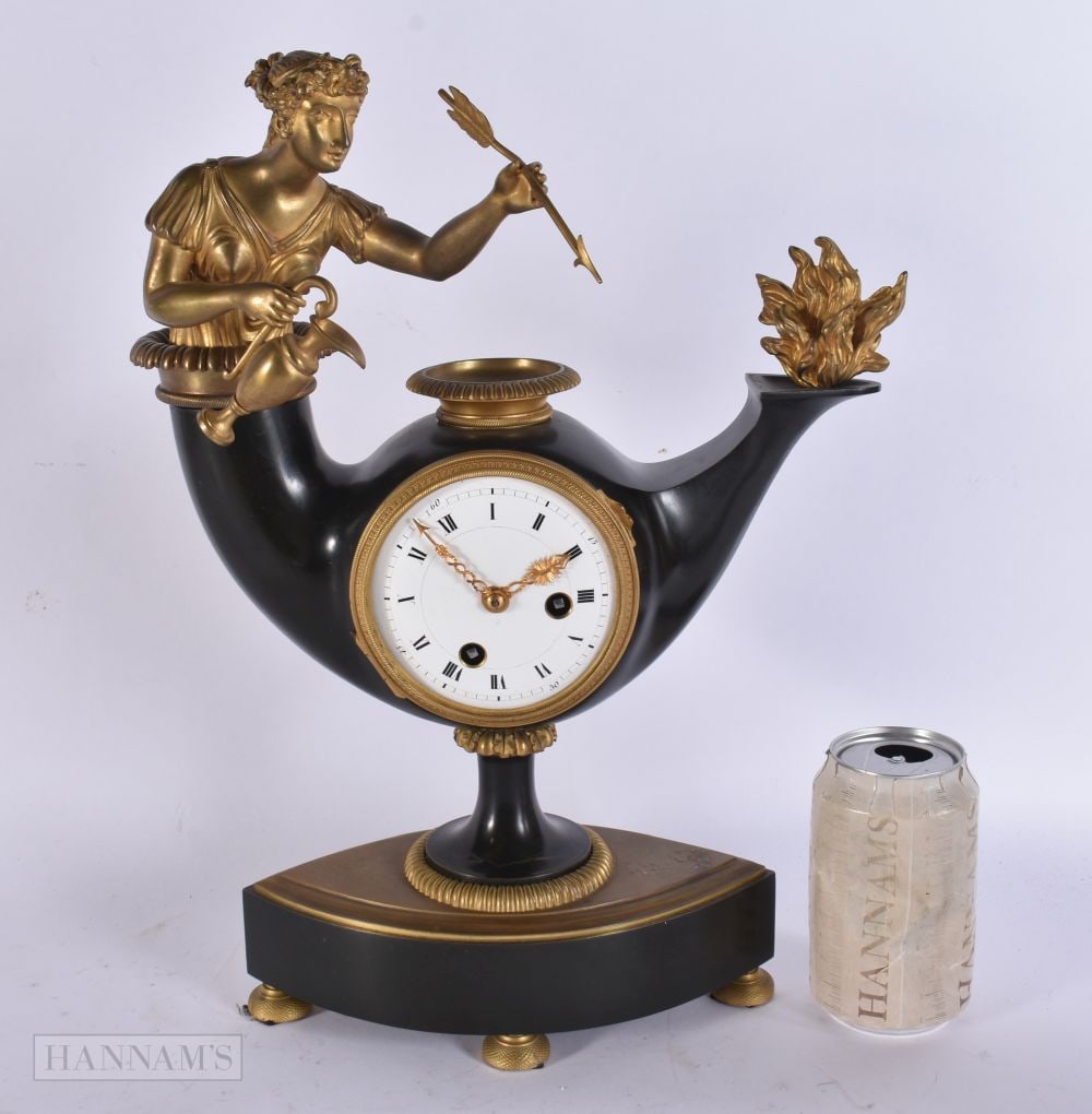 AN UNUSUAL EARLY 19TH CENTURY FRENCH RESTORATION PERIOD EMPIRE CLOCK formed with a female emerging f: AN UNUSUAL EARLY 19TH CENTURY FRENCH RESTORATION PERIOD EMPIRE CLOCK formed with a female emerging from a genie lamp. 38 cm x 26 cm.