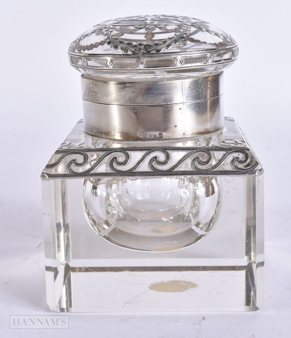 AN ANTIQUE CONTINENTAL NEO CLASSICAL SILVER MOUNTED GLASS INKWELL. 7 cm wide.: AN ANTIQUE CONTINENTAL NEO CLASSICAL SILVER MOUNTED GLASS INKWELL. 7 cm wide.