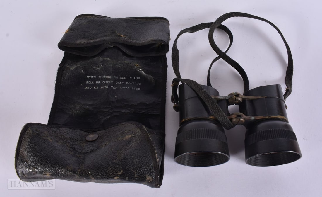 A PAIR OF MILITARY BINOCULARS in a leather case. 12 cm x 8 cm. (1 of 4)