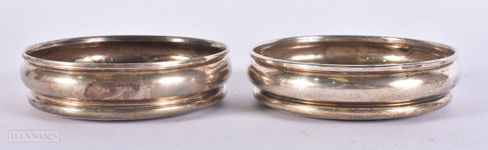 A PAIR OF SILVER BOTTLE COASTERS. 164 grams overall. 11 cm wide. (1 of 5)