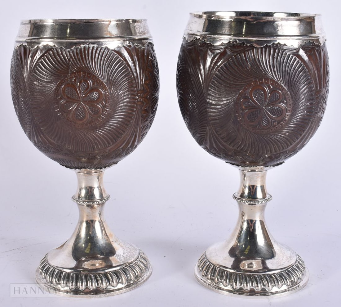 A PAIR OF EARLY 19TH CENTURY SILVER MOUNTED COCONUT CUPS by Thomas Halford, the bases engraved with (1 of 7)