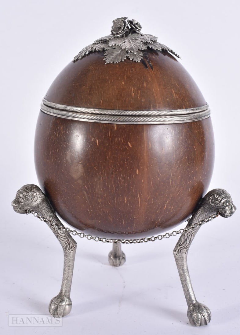 AN 18TH/19TH CENTURY SILVER MOUNTED COCONUT CUP AND COVER formed with three beast mask head legs. 18 (1 of 5)