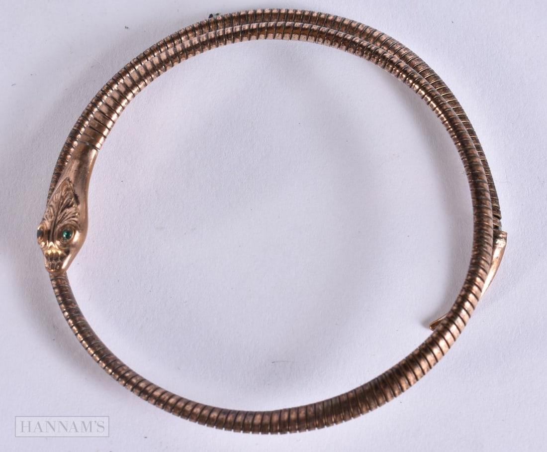 AN ANTIQUE YELLOW METAL SERPENT BANGLE. 11.1 grams. 7.5 cm wide. (1 of 5)