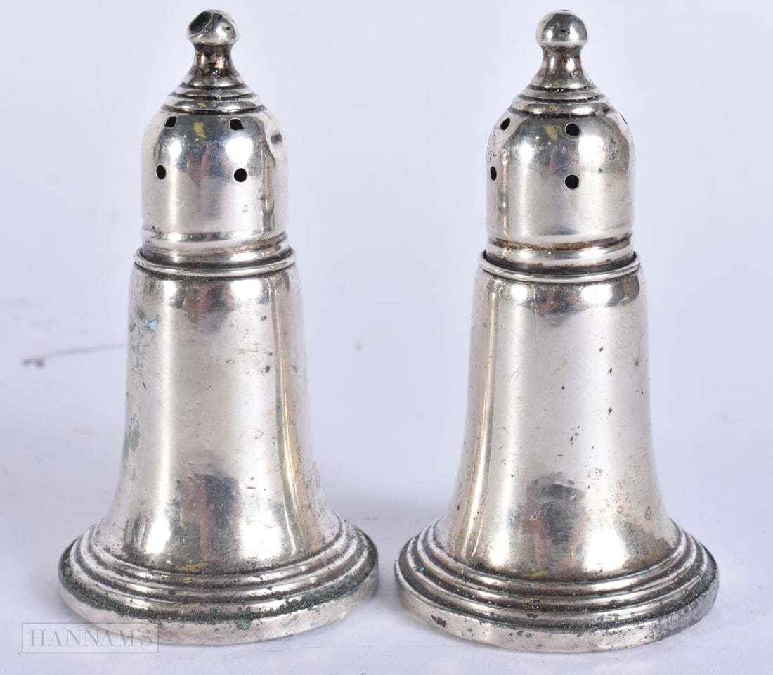 A PAIR OF SILVER CONDIMENTS. 126 grams overall. 8 cm high. (1 of 4)