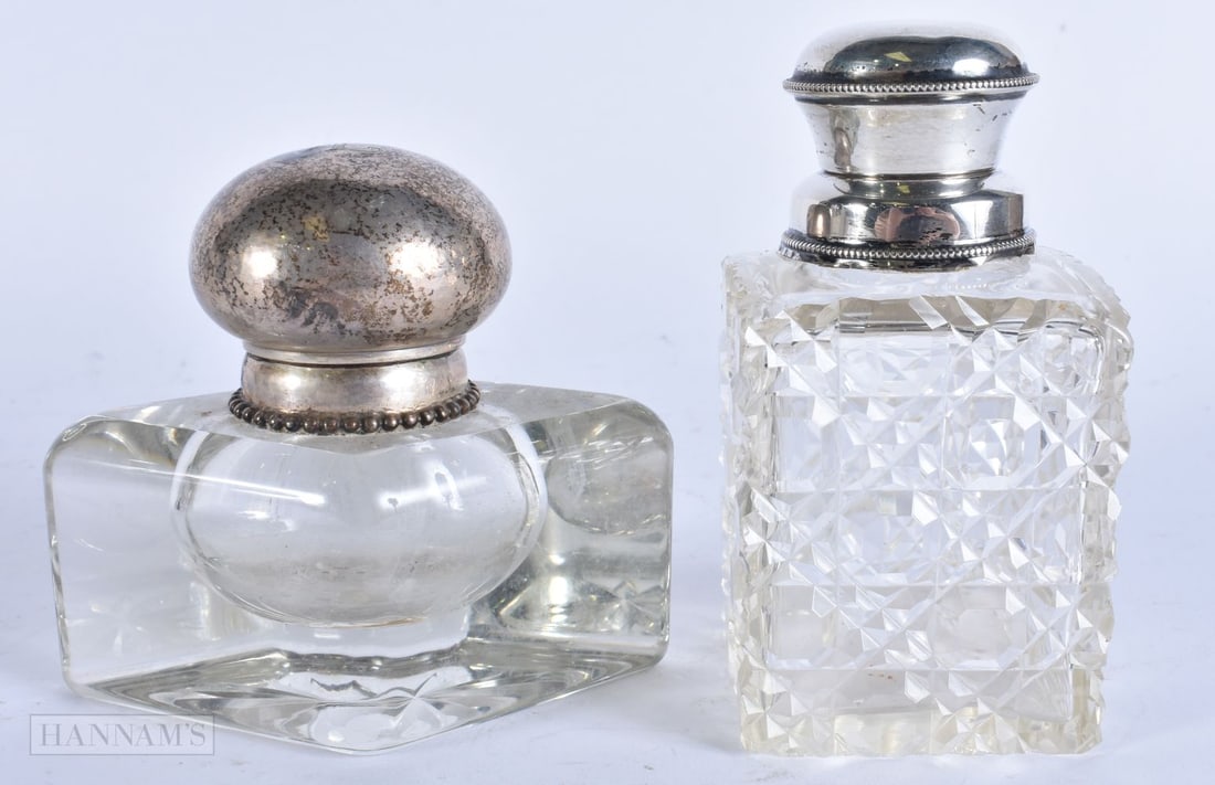 TWO ANTIQUE SILVER TOPPED INKWELLS. Largest 12 cm high. (2): TWO ANTIQUE SILVER TOPPED INKWELLS. Largest 12 cm high. (2)