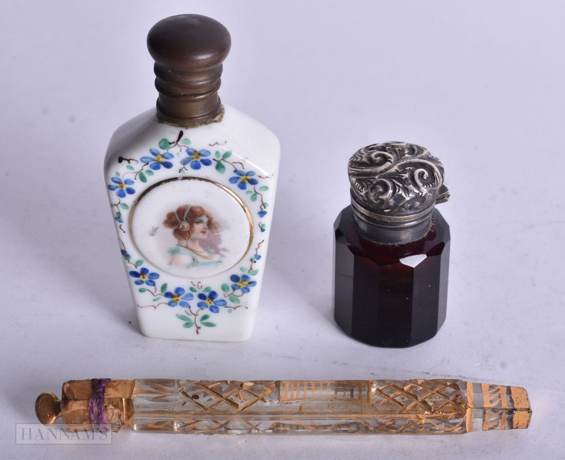 A VICTORIAN SILVER AND BLUE GLASS SCENT BOTTLE together with two others. Largest 10.5 cm long. (3) (1 of 3)