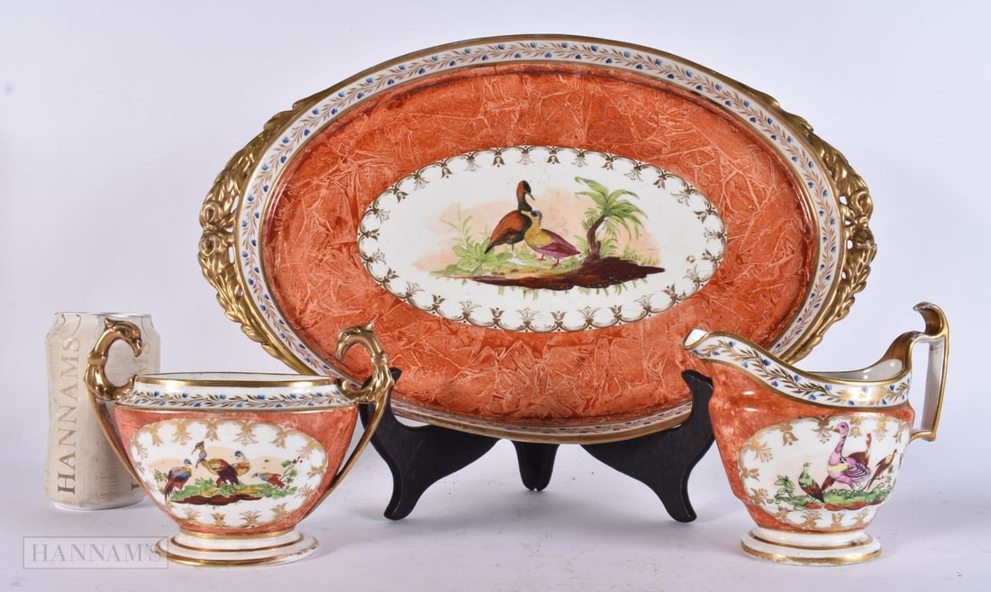 AN EARLY 19TH CENTURY ENGLISH PORCELAIN BIRDS OF PARADISE TRAY probably Coalport, with matching sucr: AN EARLY 19TH CENTURY ENGLISH PORCELAIN BIRDS OF PARADISE TRAY probably Coalport, with matching sucrier and milk jug. Largest 40 cm x 22 cm. (3)