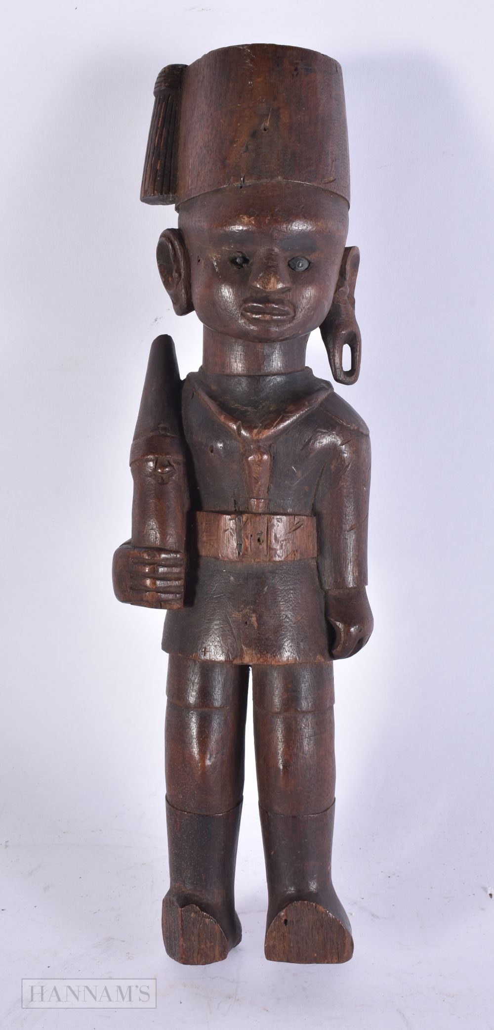 AN AFRICAN TRIBAL CARVED WOOD COLONIAL FIGURE OF A SOLDIER. 33 cm high. (1 of 4)